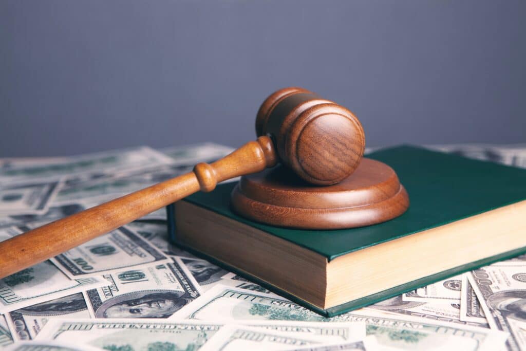 Judge's gavel on book with money